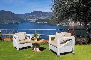 two chairs and a table with a view of the water at Lake View 30 in Sulzano
