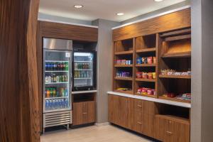 a kitchen with a refrigerator and lots of drinks at SpringHill Suites by Marriott Tucson at The Bridges in Tucson