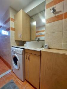 a kitchen with a washing machine and a sink at MAXIM APARTMENT in Heraklio