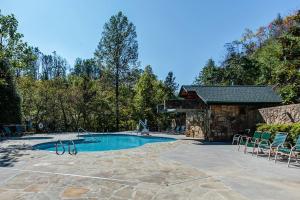 Una piscina con sillas y un edificio. en Smoky Haven, en Gatlinburg