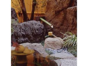 京都的住宿－kamogawa Kan - Vacation STAY 17163v，一个带喷泉和岩石的小型花园