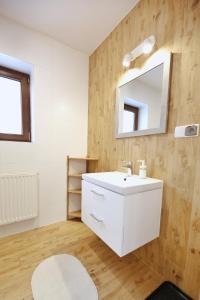 a bathroom with a white sink and a mirror at Pokoje Gościnne Stanek in Zakopane