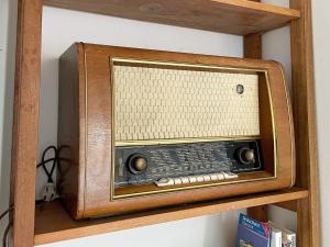 an old radio sitting on a wooden shelf at 8 person holiday home in VETLANDA-By Traum in Vetlanda