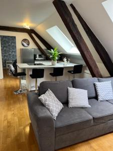 a living room with a couch and a desk at Coeur de bouchon in Troyes