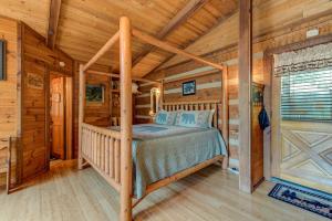 a bedroom with a bed in a log cabin at Rustic Charm in Gatlinburg +32 photos