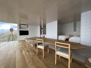 a dining room with a table and chairs and a bedroom at Cliff House MORAI - Vacation STAY 14408 in Ishikari