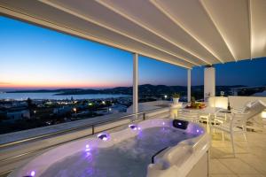 a jacuzzi tub on the balcony of a house at Panos Luxury Suite in Parikia