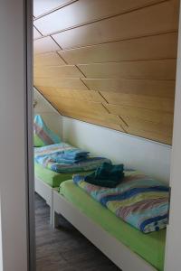two bunk beds in a room with wooden ceilings at Ferienwohnung Wegmann in Borkum +6 photos