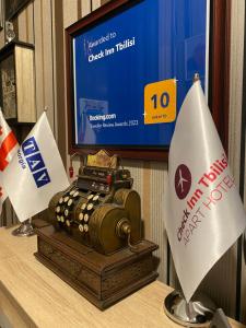 a table with a tv and a display of a camera at Check Inn Tbilisi in Tbilisi City