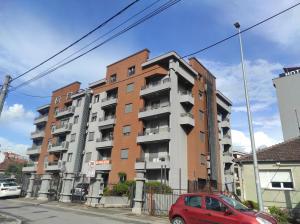 a red car parked in front of a building at Studio K in Podgorica