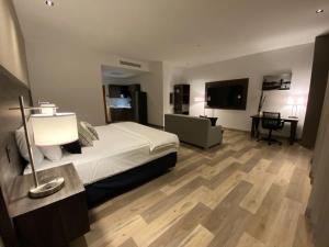 a bedroom with a bed and a desk and a television at Wyndham Garden Guatemala City in Guatemala