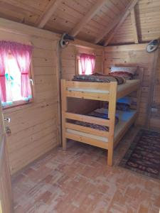 a wooden cabin with two bunk beds in it at Rafting Camp Konak in Foča