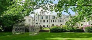 a large white house with a gate in the yard at Botleigh Grange Hotel - Pool & Spa under renovation in Southampton