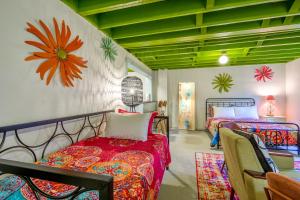 a bedroom with two beds and a wall with flowers on it at Comfy Colonial - up to 15 ppl 5 mins to Plaza District or State Fair in Oklahoma City