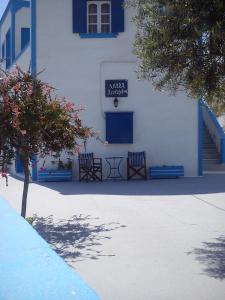 a blue and white building with a blue bench at Villa Firostefani in Firostefani