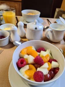 a table with a bowl of fruit on a table at Braelea in Spean Bridge +9 photos