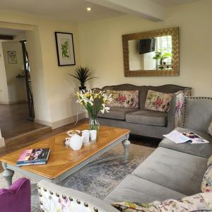 a living room with a couch and a coffee table at Brook Cottage in Kelling