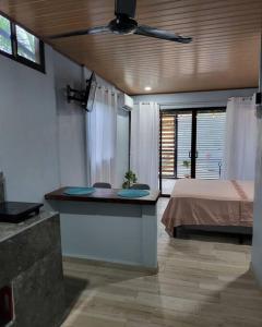 a room with a bed and a bathroom with a sink at MILA Apartments #4 in Tamarindo