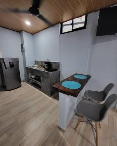 a kitchen with a table and a chair in a room at MILA Apartments #4 in Tamarindo