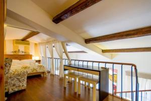 a bedroom with a bed and a staircase in a room at Appartamento Borgo Apostoli in Florence