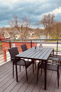 a wooden table and chairs on a deck with a view at Ferienwohnung Thiele in Rosswein in Roßwein