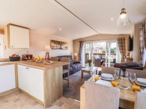 a kitchen and living room with a table and chairs at Marigold Lodge in Saltburn-by-the-Sea