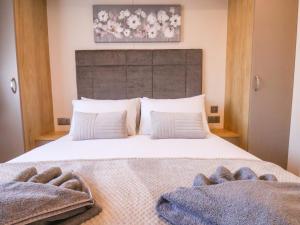 a bedroom with a large bed with two towels on it at Marigold Lodge in Saltburn-by-the-Sea