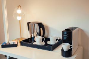 a coffee maker and two cups on a table at Torre a Mare Porto Venere in Portovenere