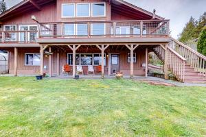a large wooden house with a porch and a yard at The Sunrise Hideout in Port Ludlow +18 photos