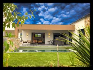 a house with a backyard with a swimming pool at VILLA Paolo in Saint-Christol-lès-Alès