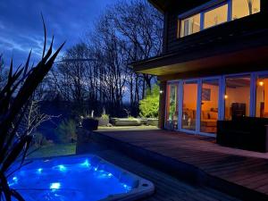 a hot tub on a deck next to a house at Kellys SPA in Kdyně