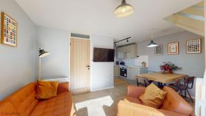 a living room with a couch and a table at 19 Strawberry Hill, Tolroy Manor in Hayle