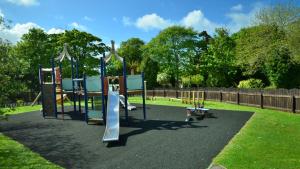 a playground with a slide in a park at 19 Strawberry Hill, Tolroy Manor in Hayle +9 photos