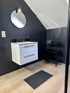 a bathroom with a white sink and a mirror at Apartamenty Avia - Energylandia Zator in Spytkowice +63 photos