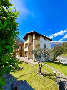a building with a tree in front of it at Casa Martina - A quiet home by the lake in Colico