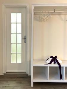 a white room with a window and a shelf with a bow at Il Ponte a Vapore Guest House in SantʼAnastasia