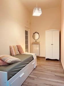 a bedroom with a bed and a white cabinet at Il Ponte a Vapore Guest House in SantʼAnastasia +12 photos