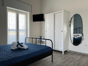 a bedroom with a bed and a mirror at Il Ponte a Vapore Guest House in SantʼAnastasia
