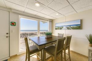 a dining room with a table and chairs and a window at Stunning Beachfront Condo with Panoramic Ocean View in Wildwood Crest