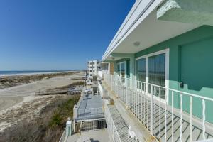 a building with a balcony overlooking the beach at Stunning Beachfront Condo with Panoramic Ocean View in Wildwood Crest