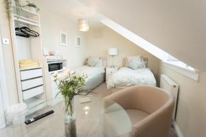 a small room with two beds and a table at 3 Private bedrooms attached to hosts home Free parking in Perth