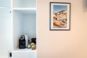 a room with a white closet with a picture on the wall at MARE LUNA in Maiori
