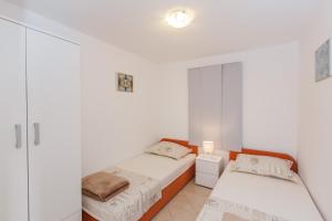 Postel nebo postele na pokoji v ubytování Apartments Viljac