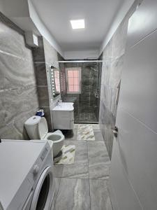 a bathroom with a toilet and a sink at Bala Apartment in Shkodër