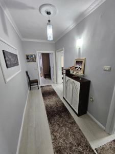 a room with a hallway with a table and a chair at Bala Apartment in Shkodër