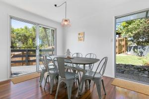a dining room with a table and chairs at 5 Plover Street Peregian Beach in Peregian Beach +10 photos