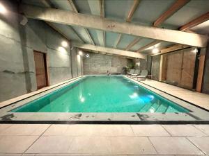 a swimming pool in an old building with at B&B 't Zwaluwnest in Heuvelland