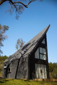 um celeiro negro com um telhado de gambrel em Cabanas Cold Mountain em Urubici