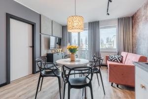 a living room with a table and chairs and a couch at Platinum Premium Apartment in Grudziądz