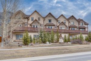 a large house on the side of a road at Cozy 1 bedroom Apartment Canmore / Banff in Canmore